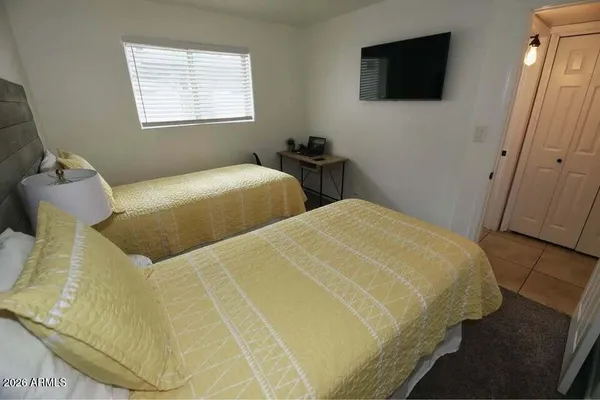 a bedroom with a bed and a flat screen tv