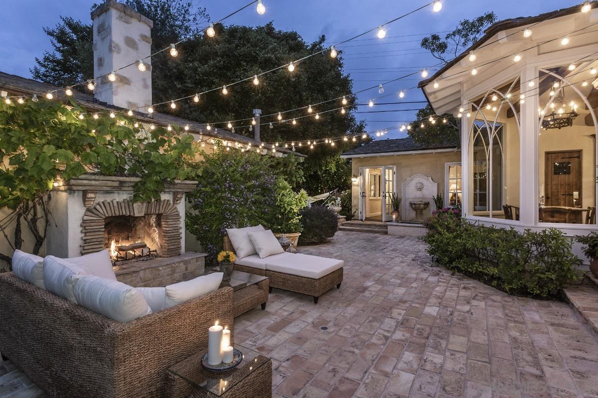 a living room with patio furniture and a fireplace