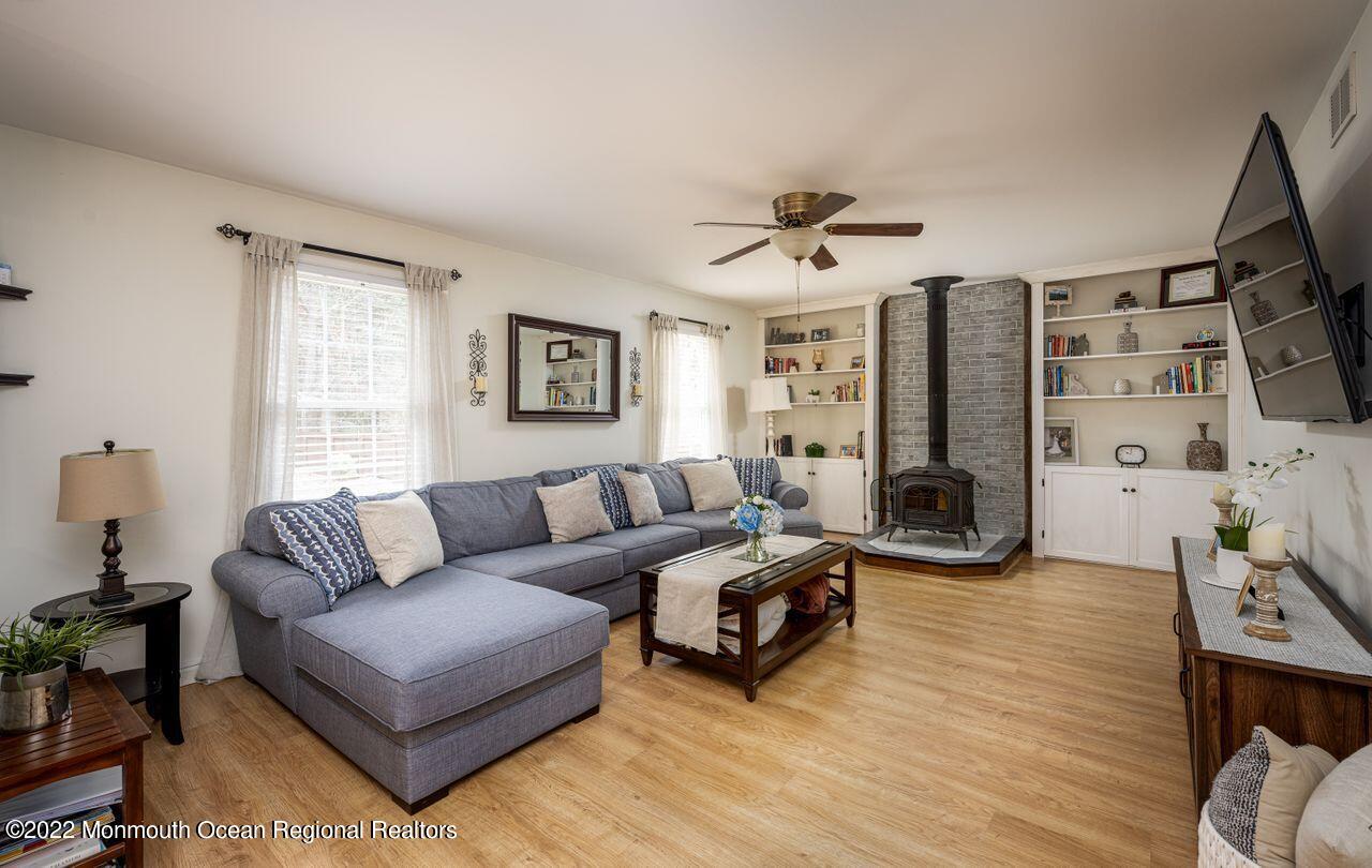 621 Reed Road Jackson, NJ 08527 - Photo 14 of 35 a living room with furniture flat screen tv and a fireplace