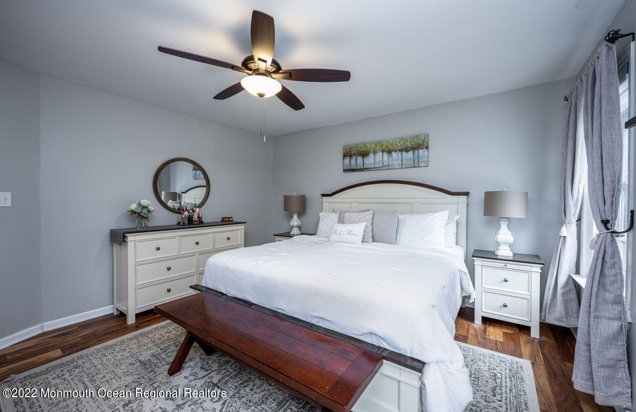 621 Reed Road Jackson, NJ 08527 - Photo 21 of 35 a bedroom with a bed and a chandelier