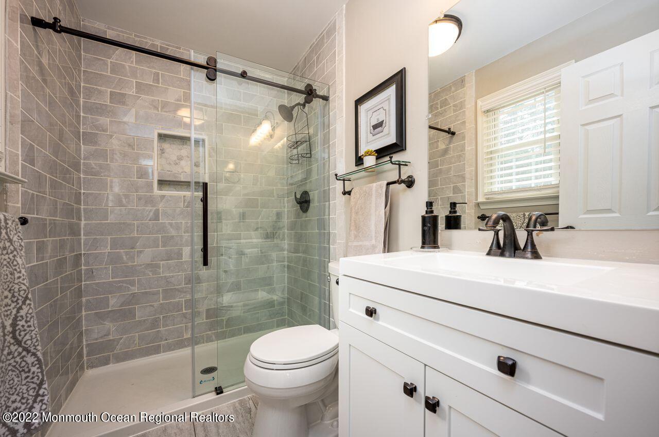 621 Reed Road Jackson, NJ 08527 - Photo 23 of 35 a bathroom with a bathtub shower sink vanity mirror and toilet