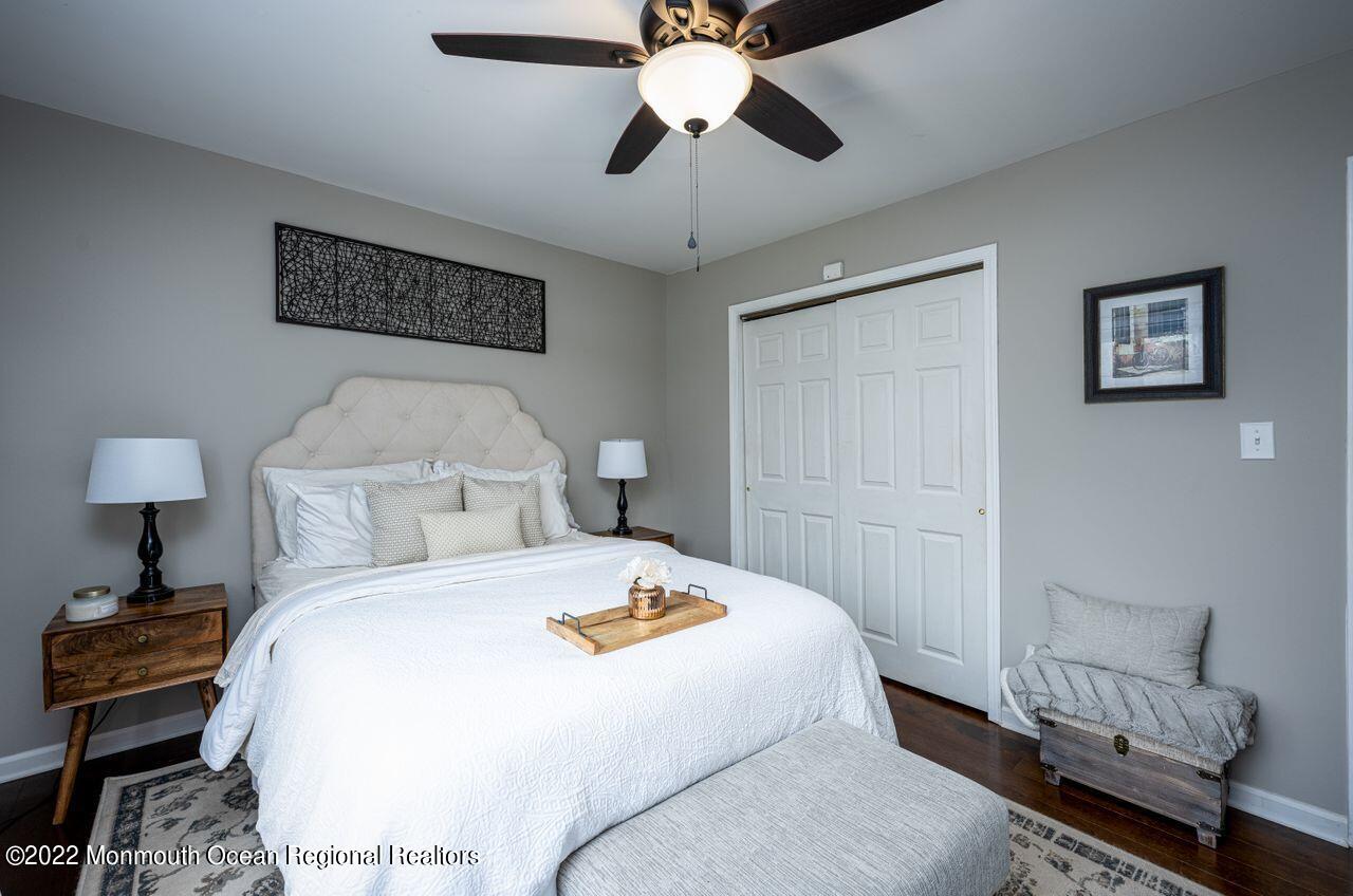 621 Reed Road Jackson, NJ 08527 - Photo 24 of 35 a bedroom with a bed and a chandelier