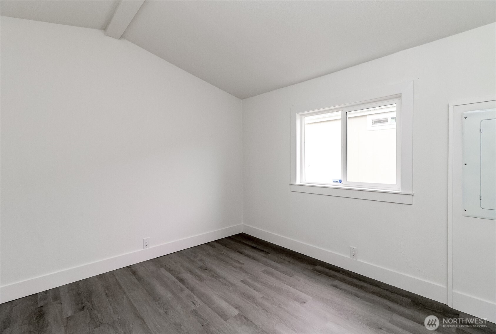 210 37th Street Southeast, Unit 35 Auburn, WA 98002 - Photo 19 of 39 an empty room with wooden floor and windows