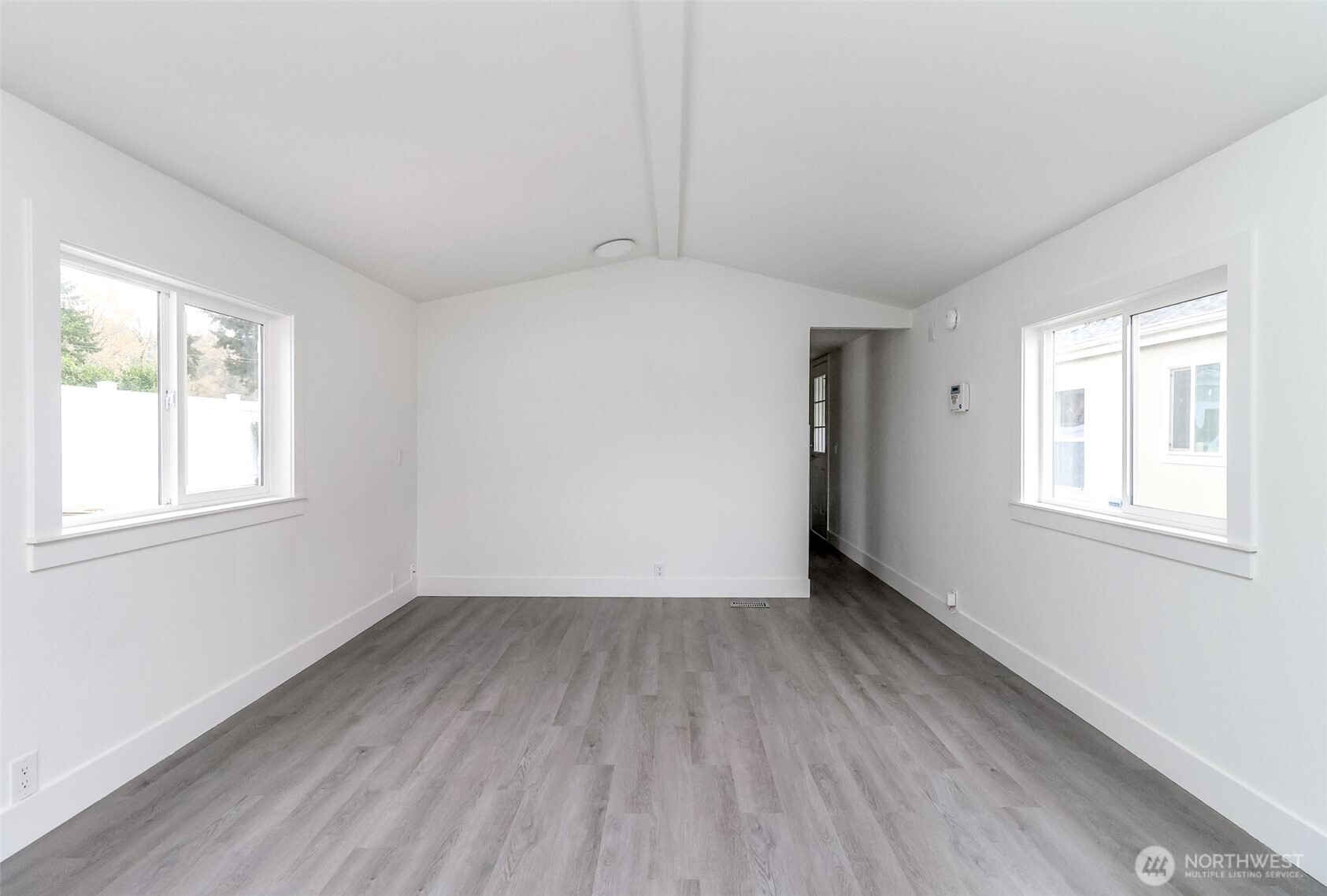 210 37th Street Southeast, Unit 35 Auburn, WA 98002 - Photo 22 of 39 an empty room with wooden floor and windows