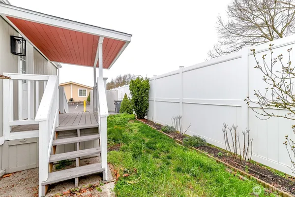 a view of a balcony with wooden floor and outdoor space