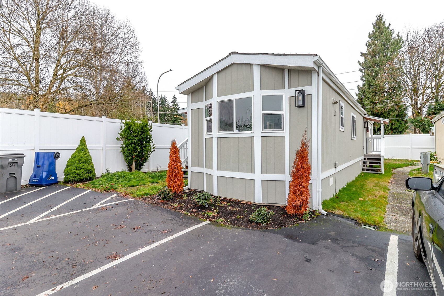 210 37th Street Southeast, Unit 35 Auburn, WA 98002 - Photo 28 of 39 a front view of a house with a yard and garage