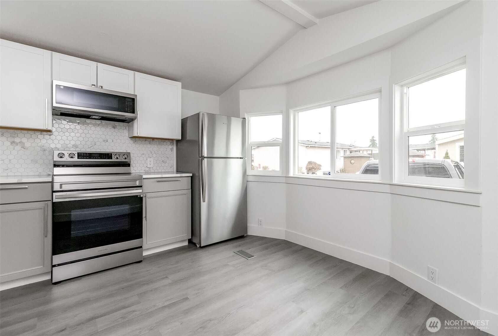 210 37th Street Southeast, Unit 35 Auburn, WA 98002 - Photo 6 of 39 a kitchen with stainless steel appliances a stove a sink and a refrigerator