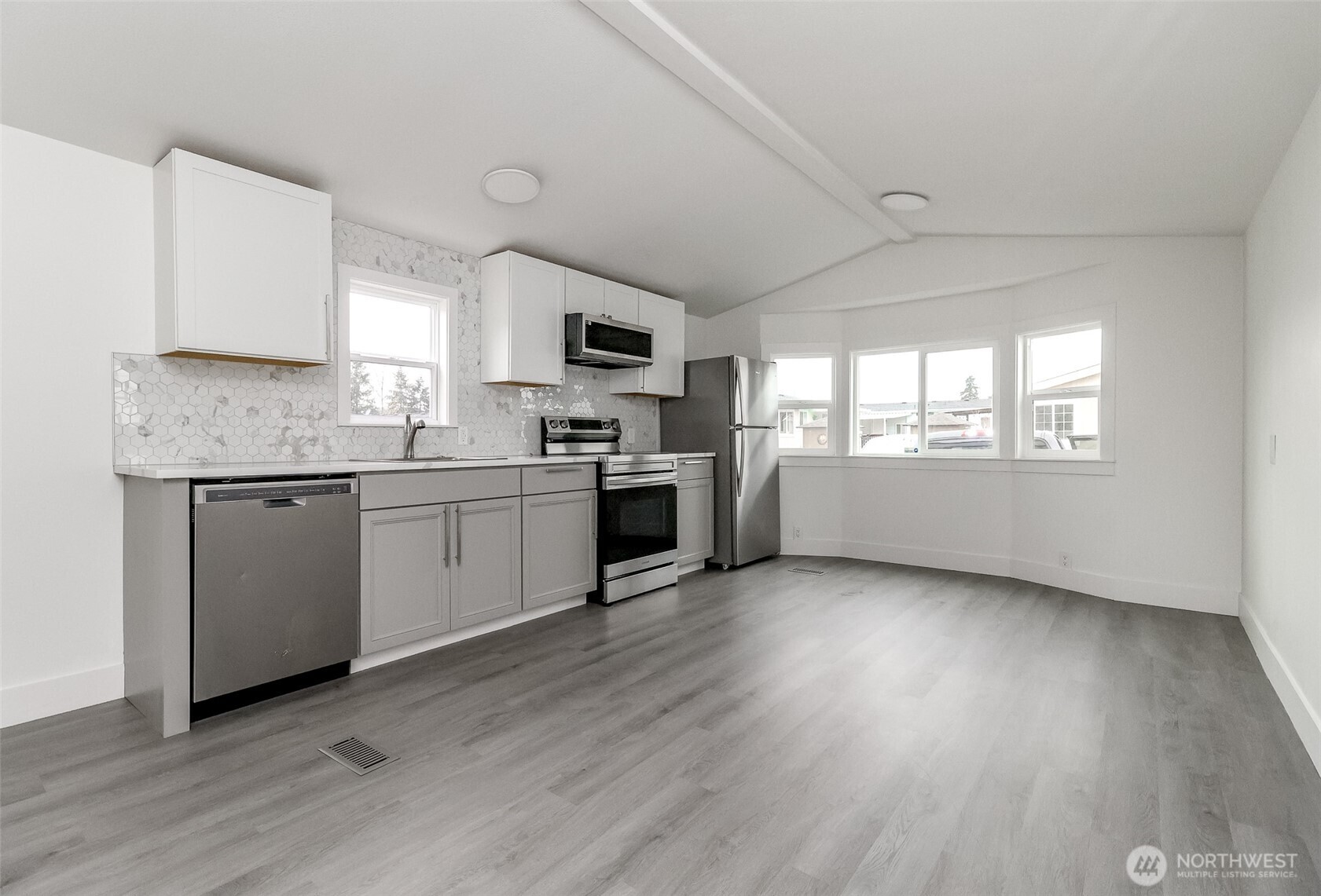 210 37th Street Southeast, Unit 35 Auburn, WA 98002 - Photo 7 of 39 a kitchen with a sink a window and stainless steel appliances