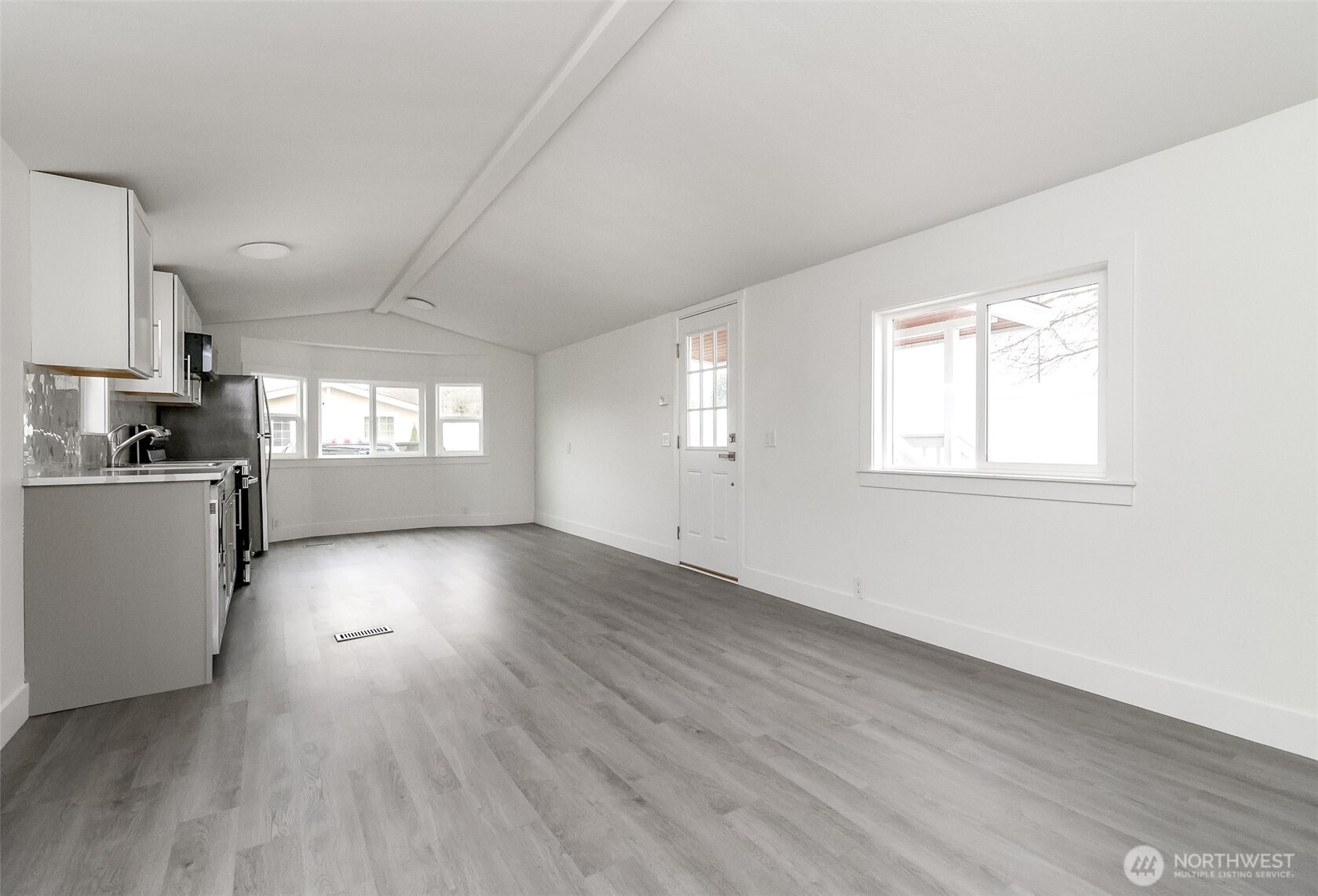 210 37th Street Southeast, Unit 35 Auburn, WA 98002 - Photo 9 of 39 an empty room with wooden floor and windows