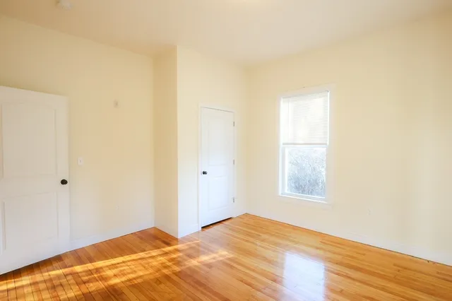a view of an empty room and wooden floor