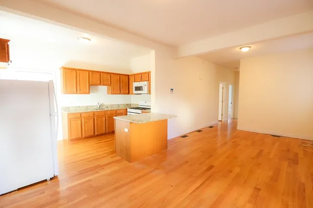a view of kitchen and wooden floor