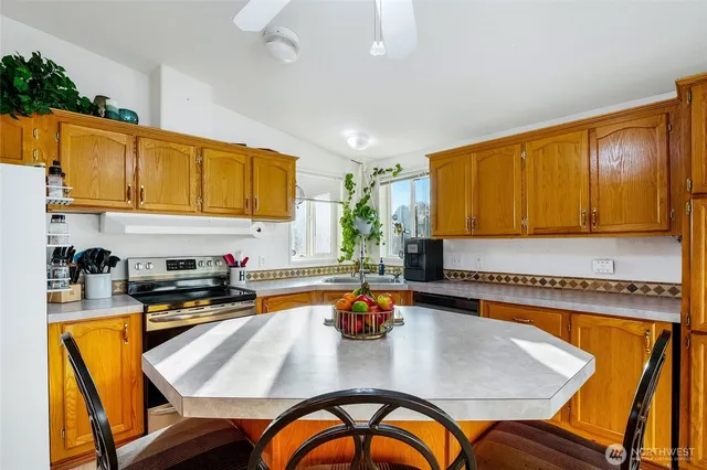 a kitchen with a table chairs sink and cabinets