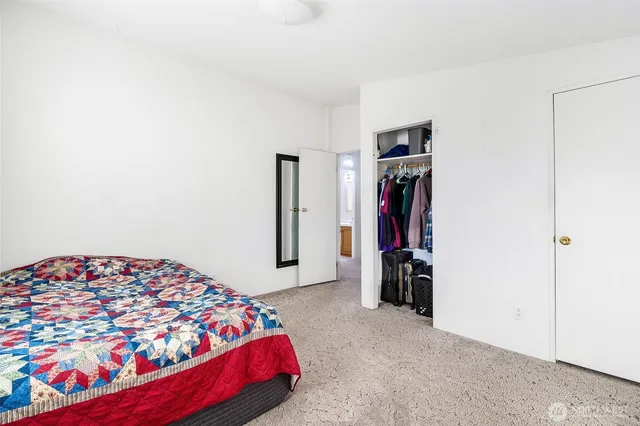 a bedroom with bed and wooden floor