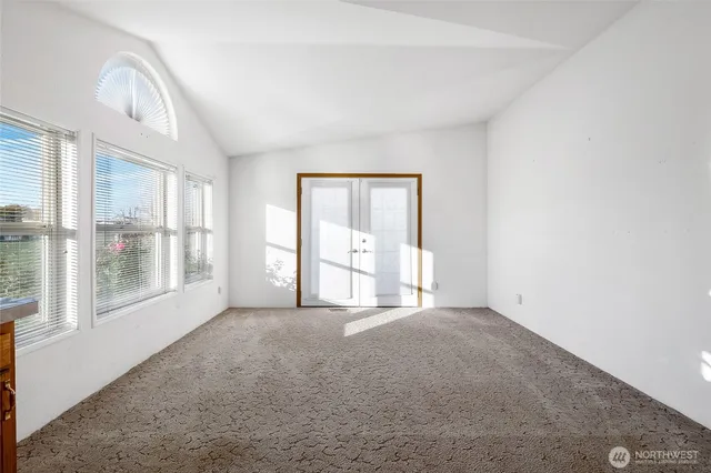 a view of a hallway with furniture and front door