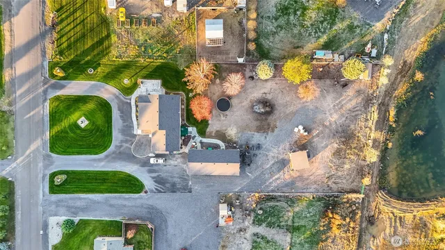 an aerial view of a house with garden space and lake view