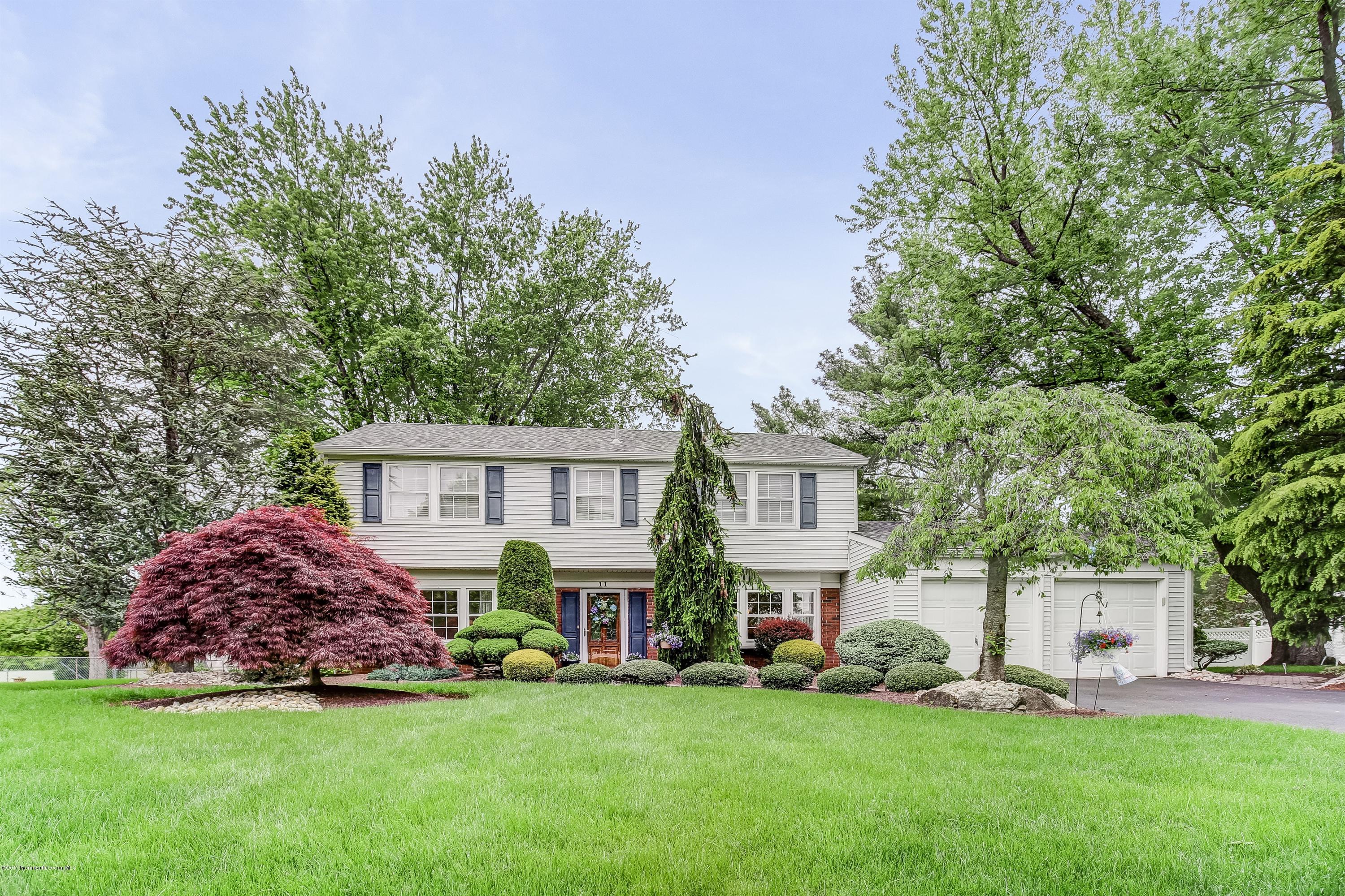 11 Applegate Road Freehold, NJ 07728 - Photo 1 of 23 a view of a house with a big yard and large trees