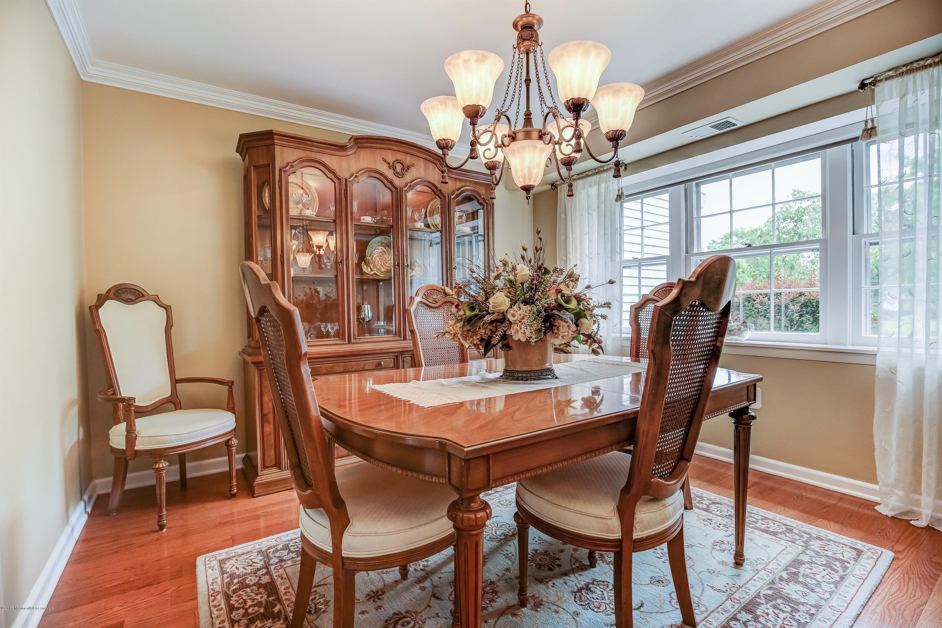 11 Applegate Road Freehold, NJ 07728 - Photo 8 of 23 a dining room with furniture a chandelier and wooden floor