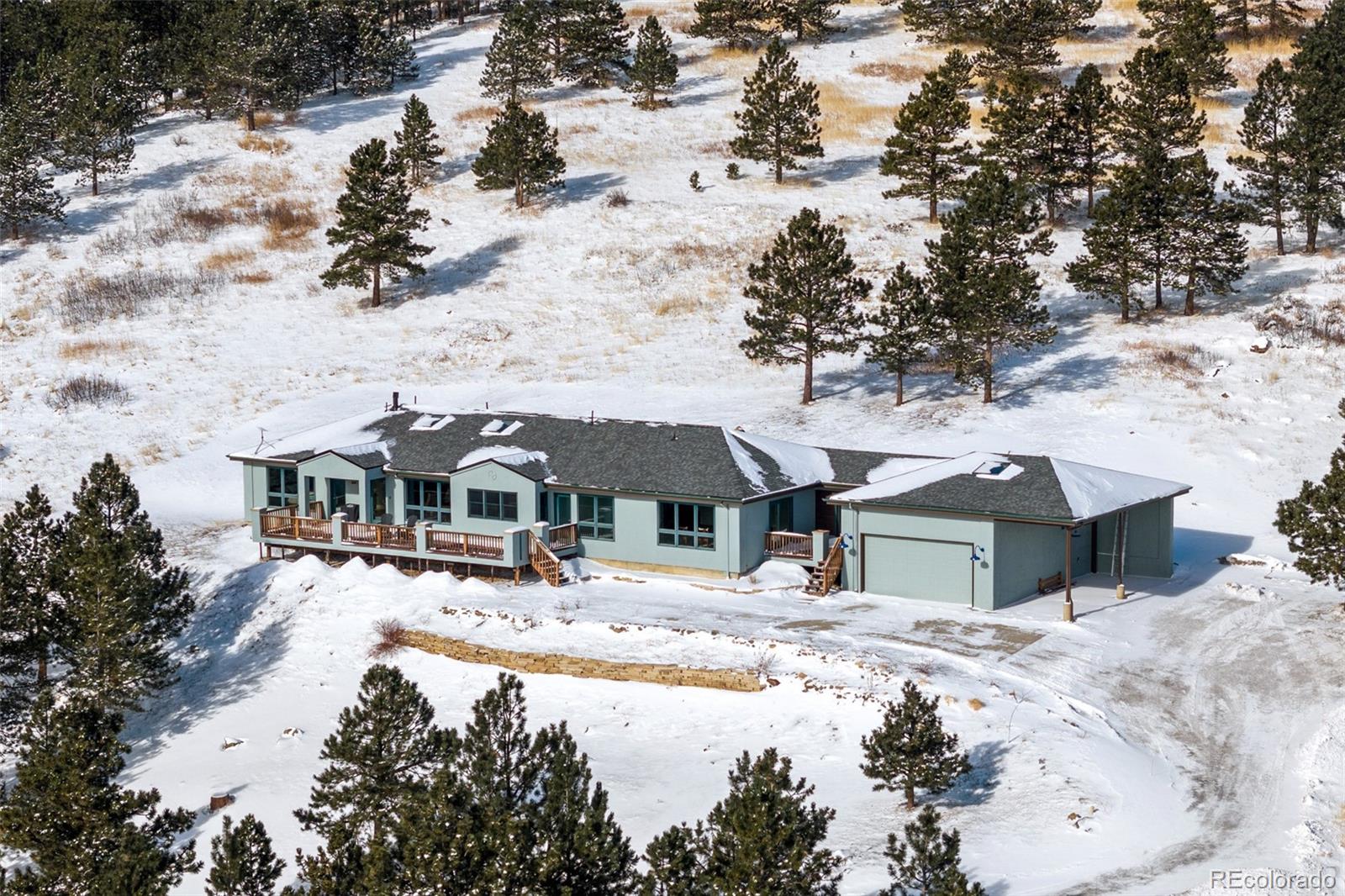 240 Dixon Road Boulder, CO 80302 - Photo 1 of 40 a front view of a house with a yard covered with snow in front of it