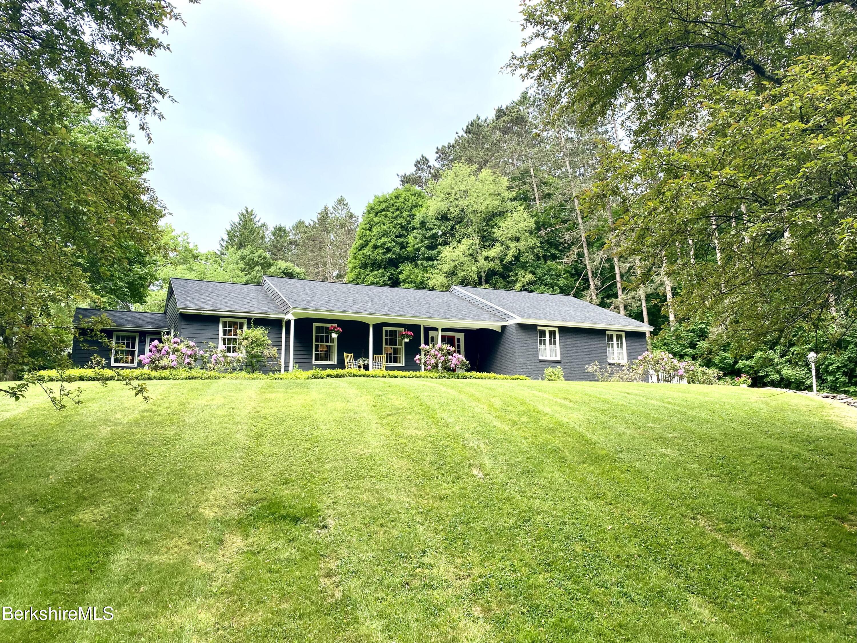 a front view of a house with a garden