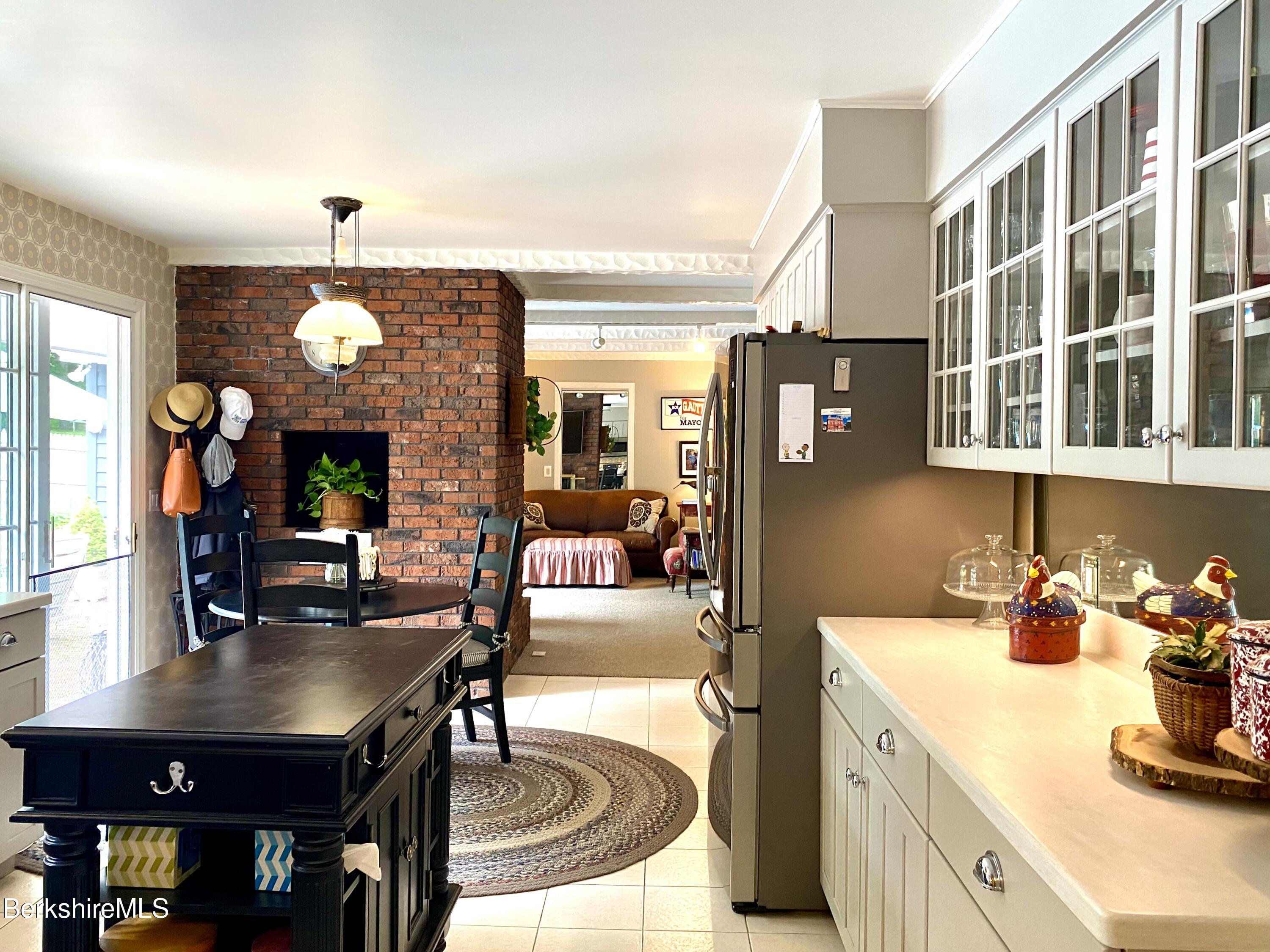 501 Holmes Road Pittsfield, MA 01201 - Photo 11 of 30 a kitchen with a chandelier dining table and chairs