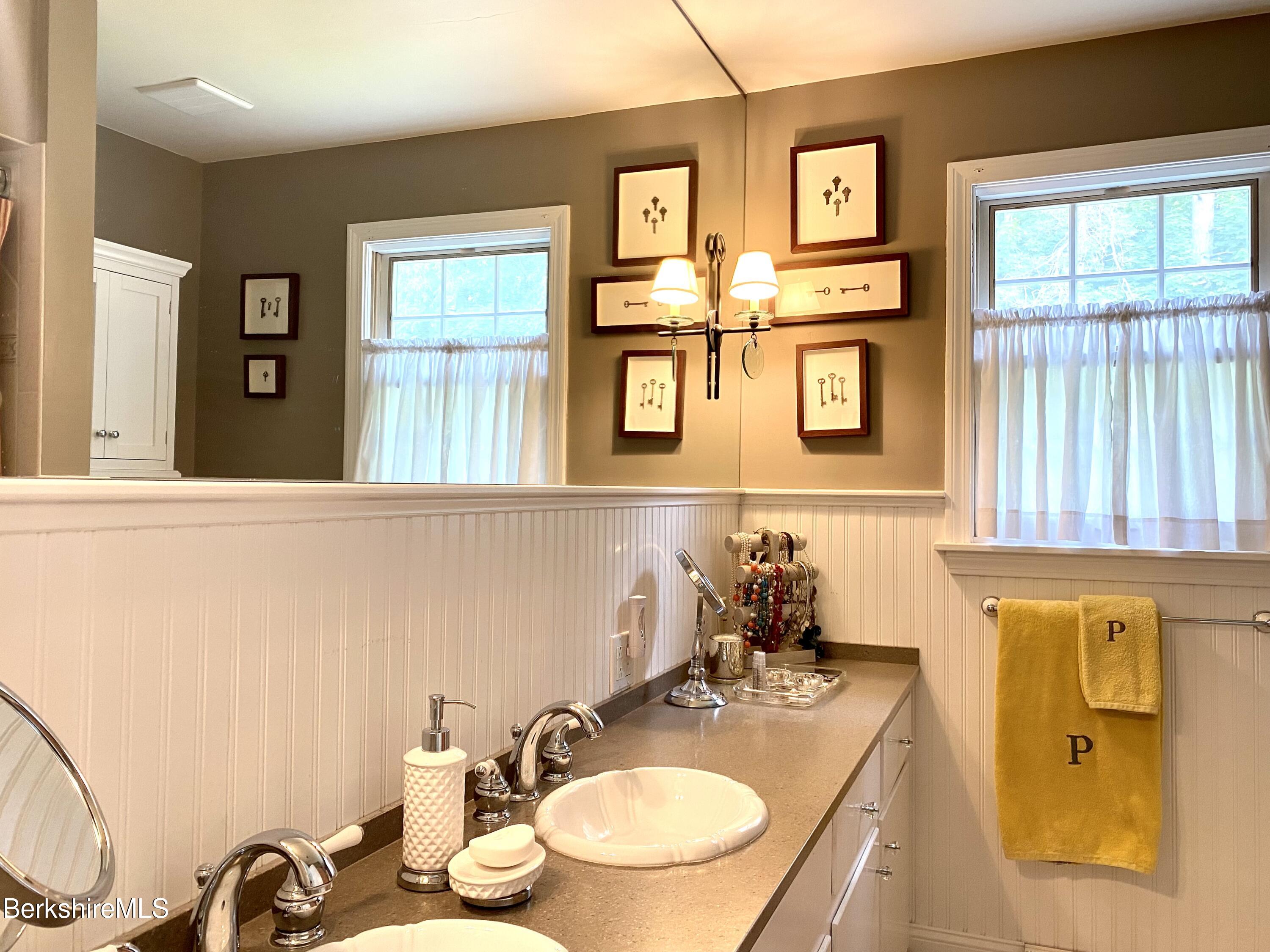 501 Holmes Road Pittsfield, MA 01201 - Photo 20 of 30 a bathroom with a granite countertop sink and a mirror