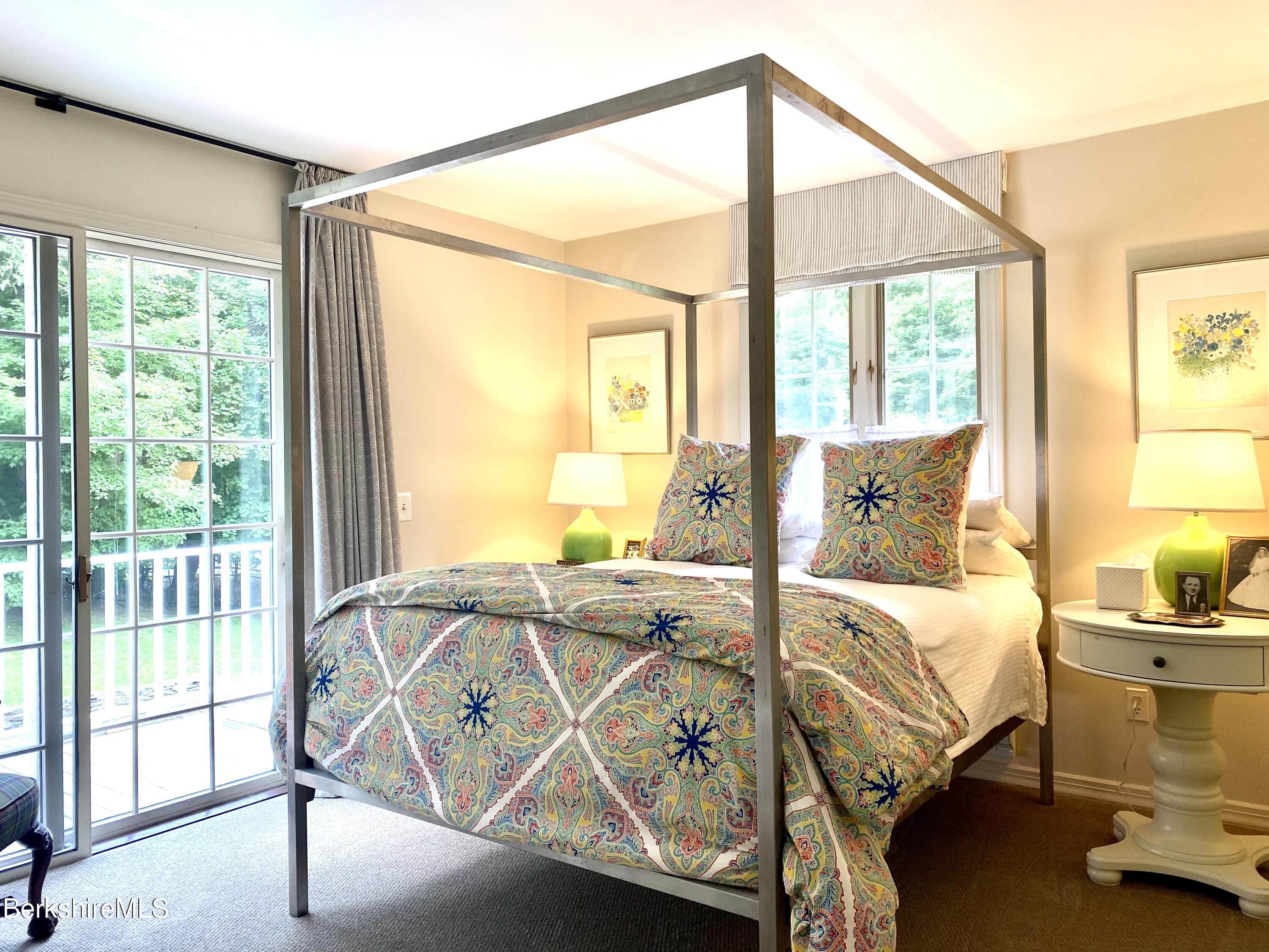 501 Holmes Road Pittsfield, MA 01201 - Photo 22 of 30 a bedroom with a bed and glass door