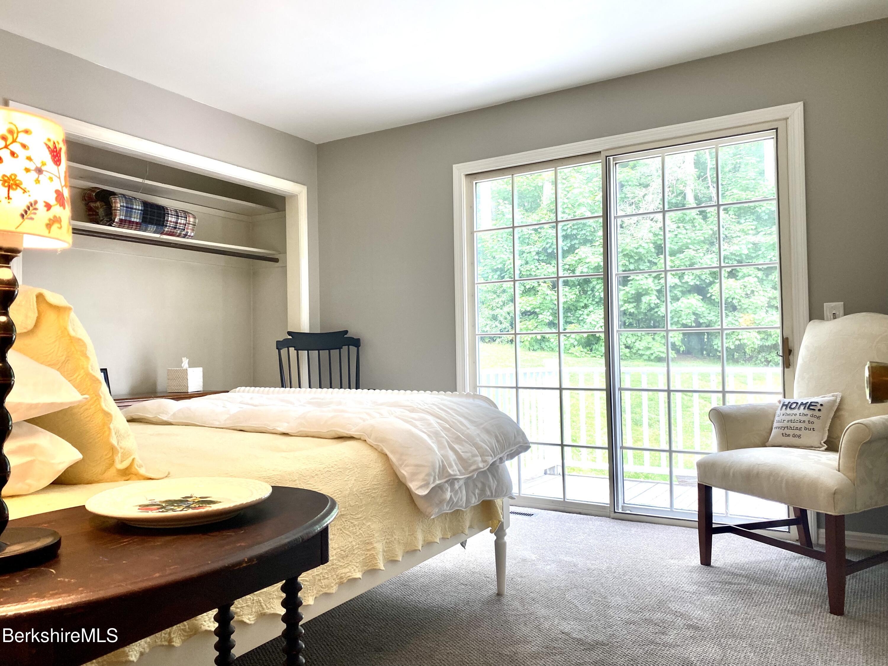 501 Holmes Road Pittsfield, MA 01201 - Photo 24 of 30 a bedroom with a bed and a chair