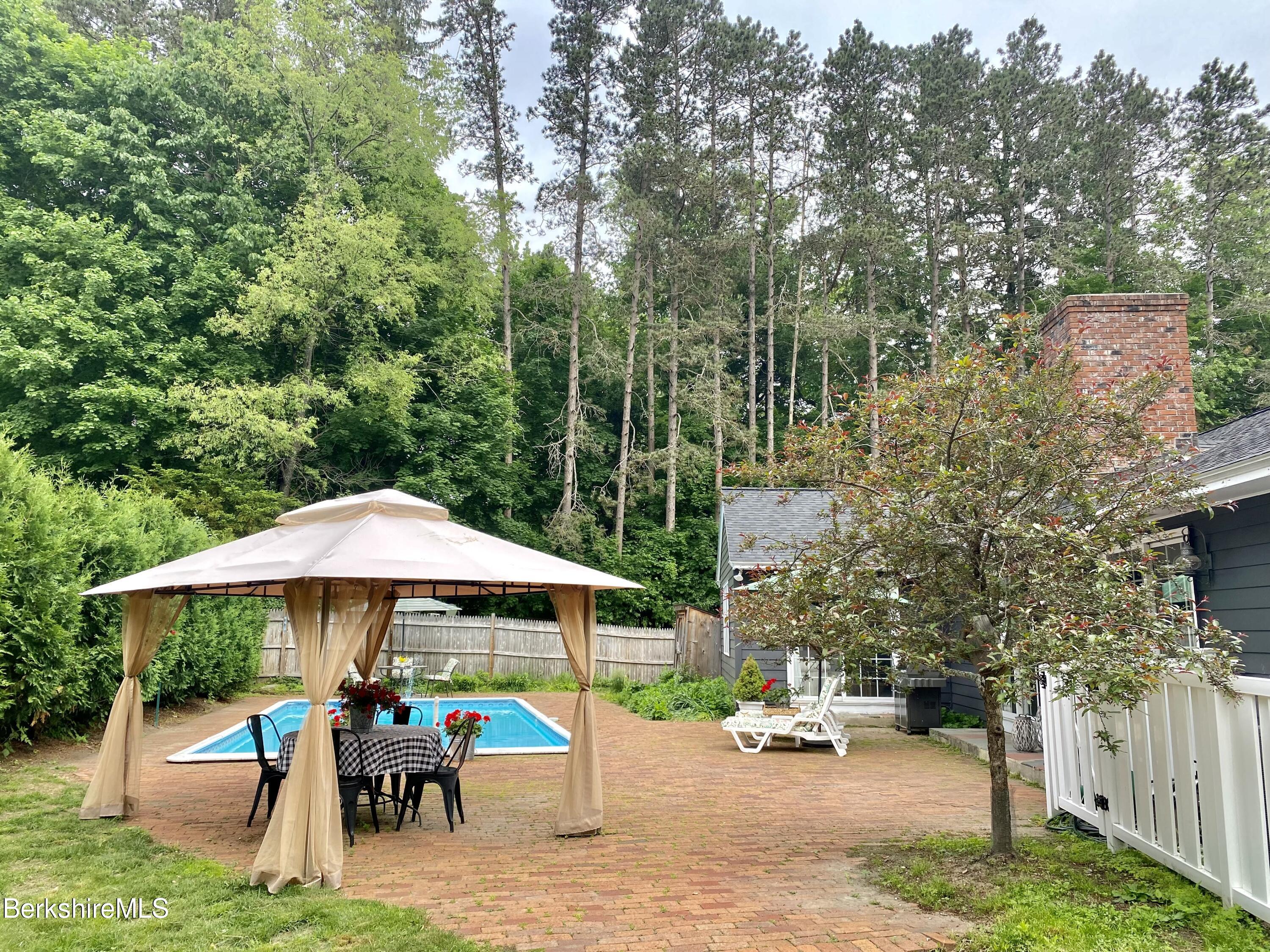 501 Holmes Road Pittsfield, MA 01201 - Photo 26 of 30 a view of a patio with a table and chairs under an umbrella