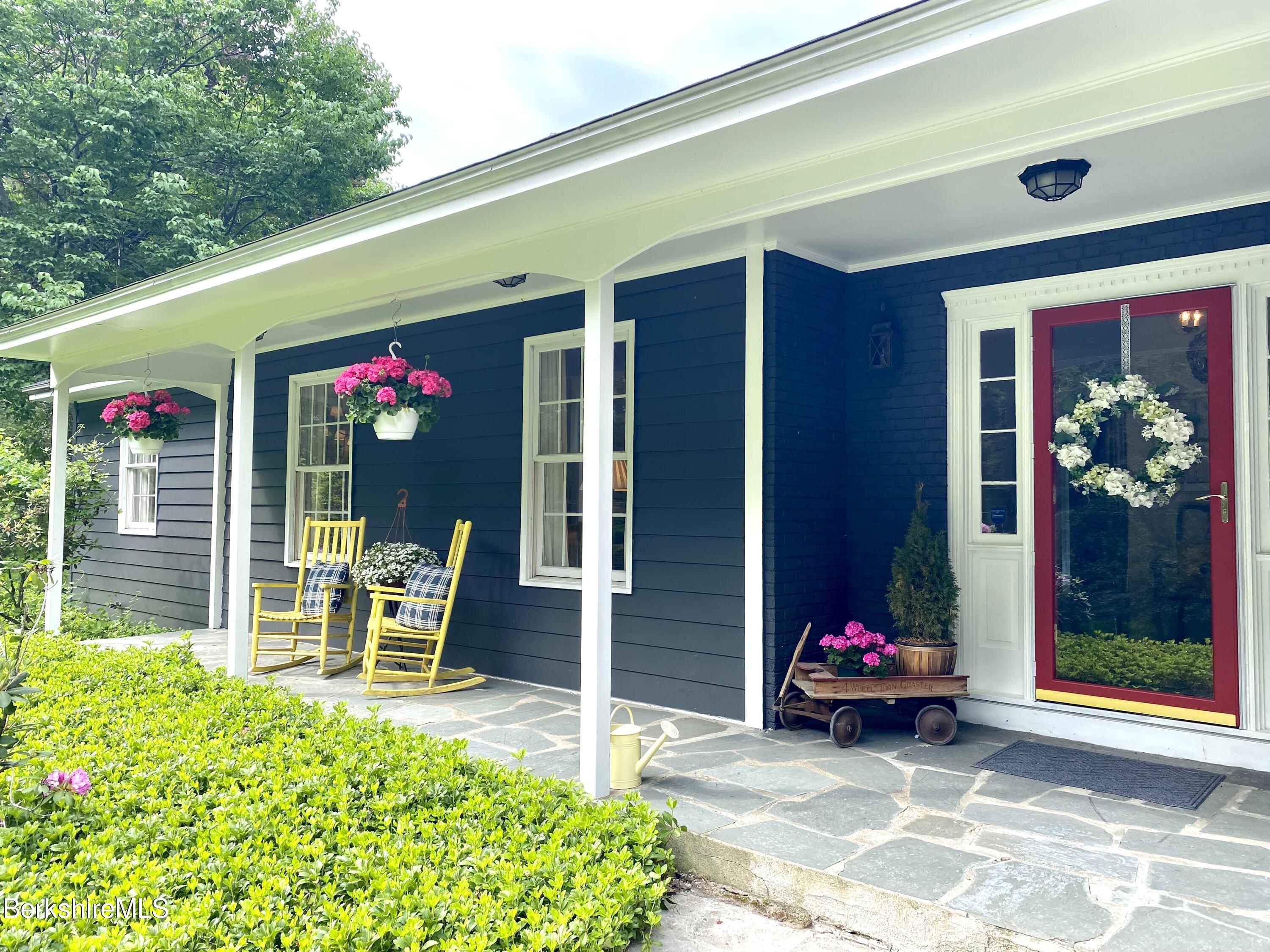 501 Holmes Road Pittsfield, MA 01201 - Photo 28 of 30 a view of a chairs and table in backyard of the house