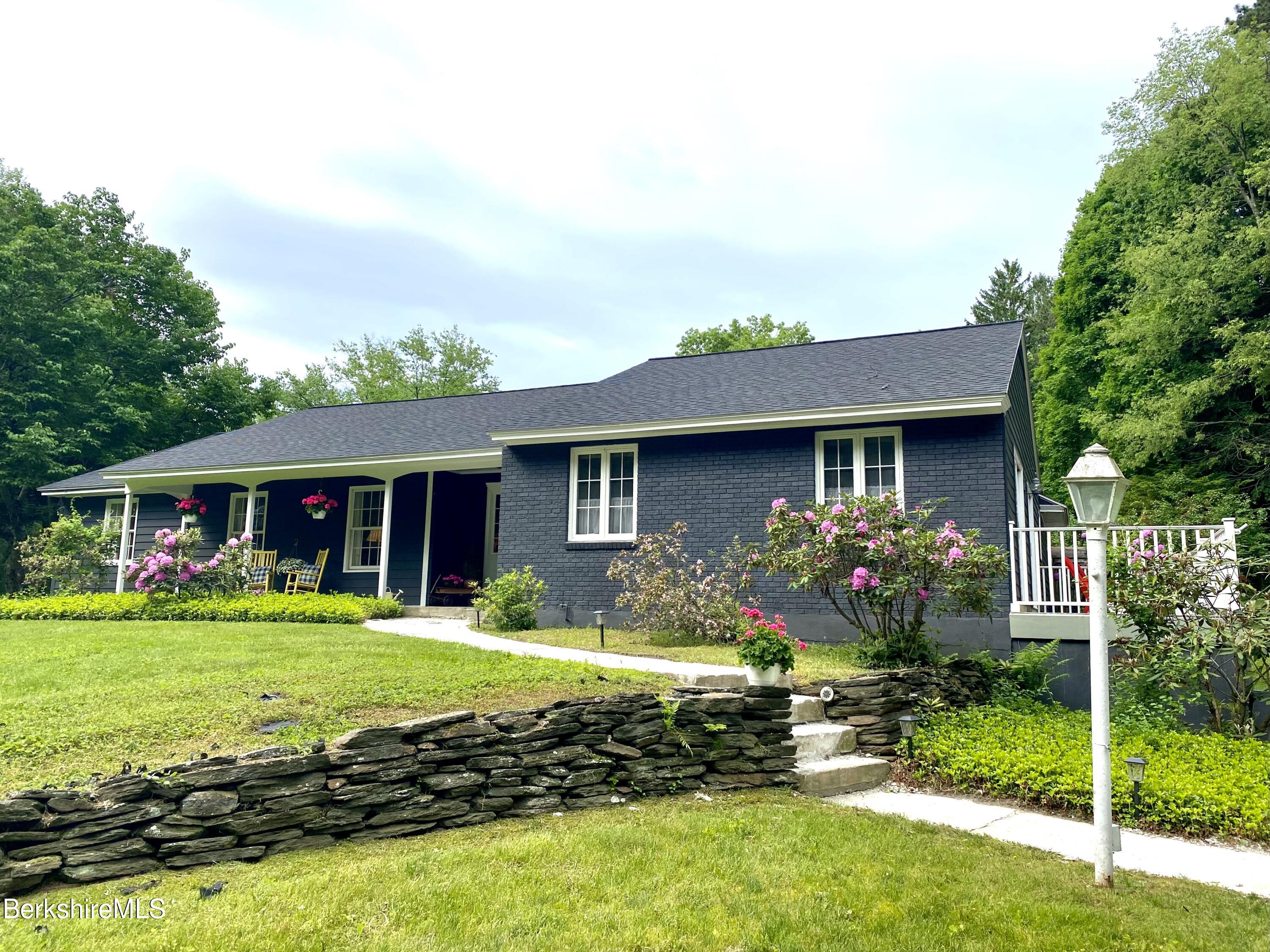 501 Holmes Road Pittsfield, MA 01201 - Photo 29 of 30 a front view of house with yard and outdoor seating