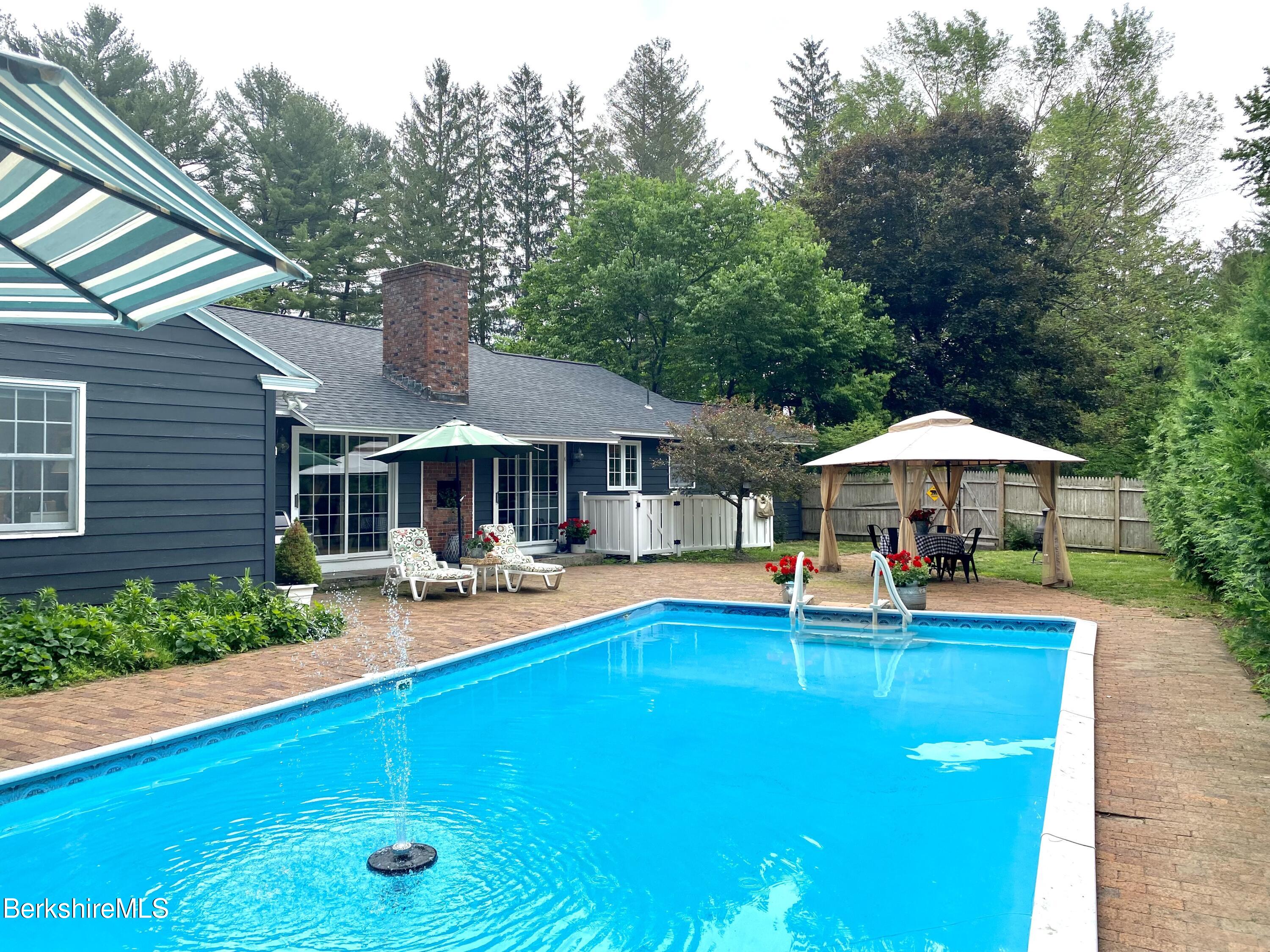 501 Holmes Road Pittsfield, MA 01201 - Photo 4 of 30 a view of a swimming pool with lounge chairs in patio