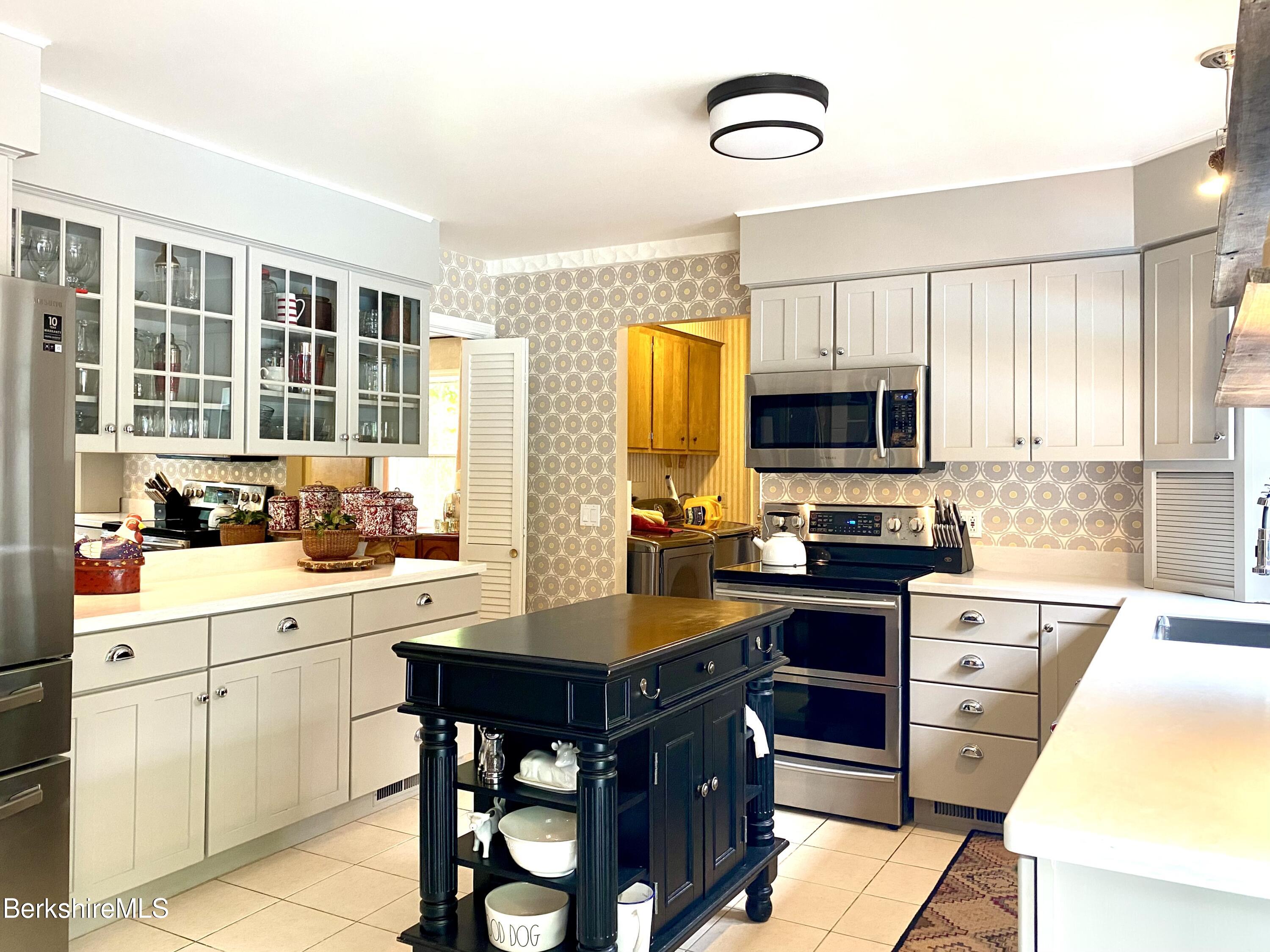 501 Holmes Road Pittsfield, MA 01201 - Photo 9 of 30 a kitchen with a sink appliances cabinets and furniture