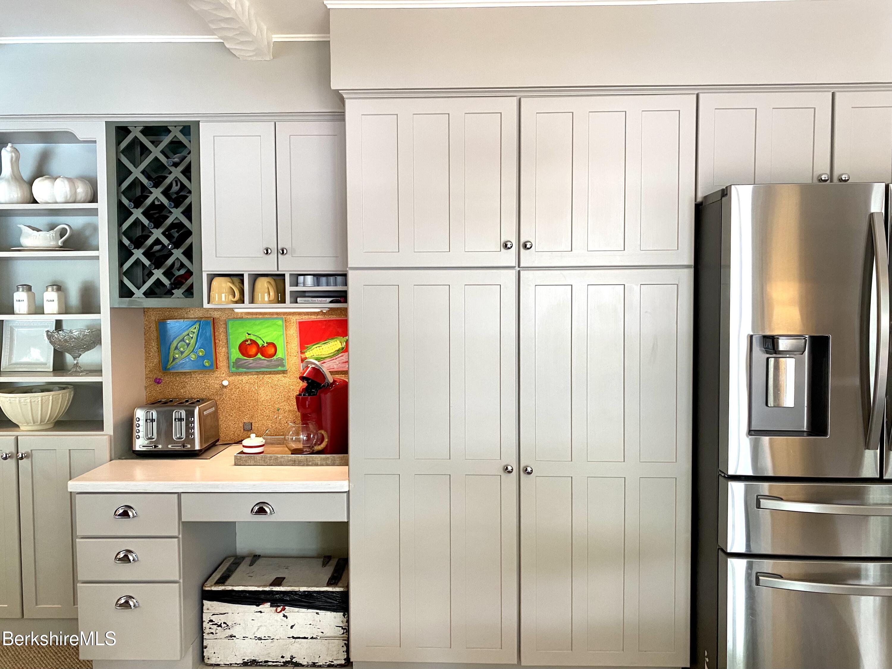 501 Holmes Road Pittsfield, MA 01201 - Photo 10 of 30 a kitchen with stainless steel appliances refrigerator and cabinets