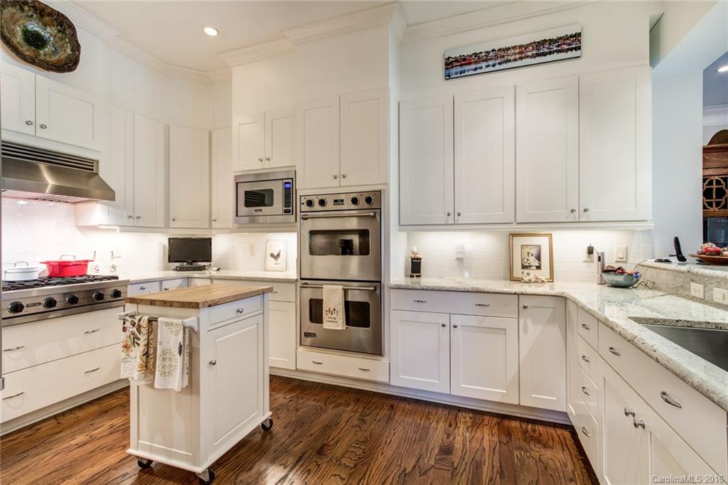 2823 Providence Road, Unit 255 Charlotte, NC 28211 - Photo 11 of 24 a kitchen with white cabinets and white appliances