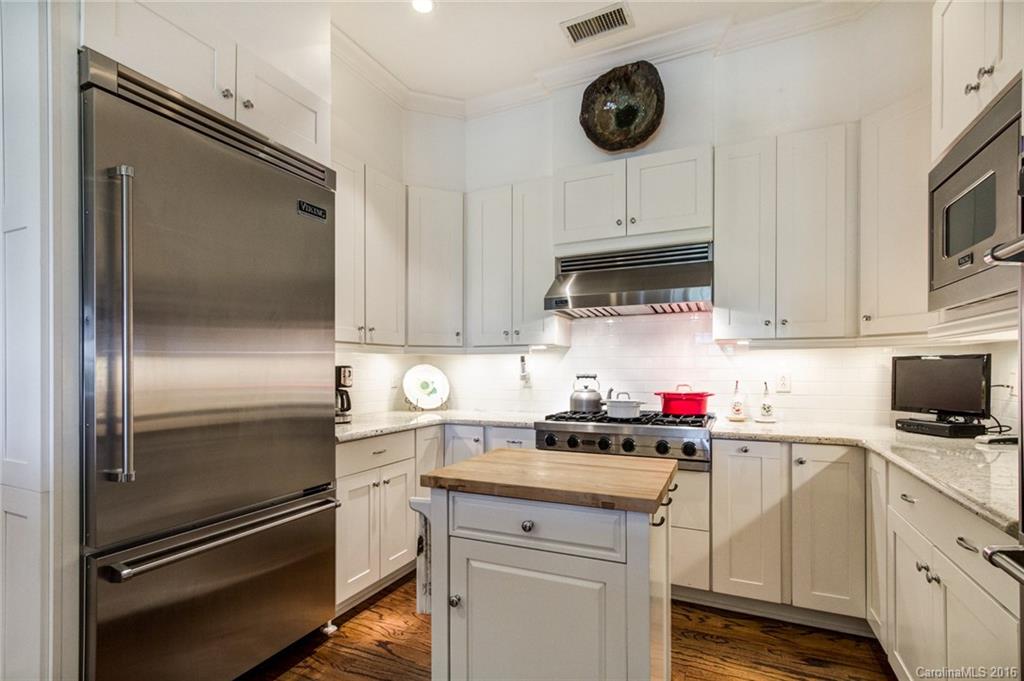 2823 Providence Road, Unit 255 Charlotte, NC 28211 - Photo 12 of 24 a kitchen with a refrigerator sink and cabinets