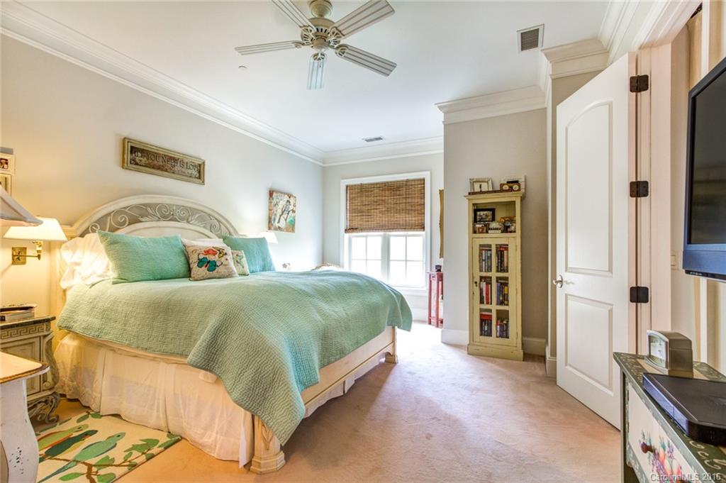 2823 Providence Road, Unit 255 Charlotte, NC 28211 - Photo 14 of 24 a bedroom with a large bed and a chandelier