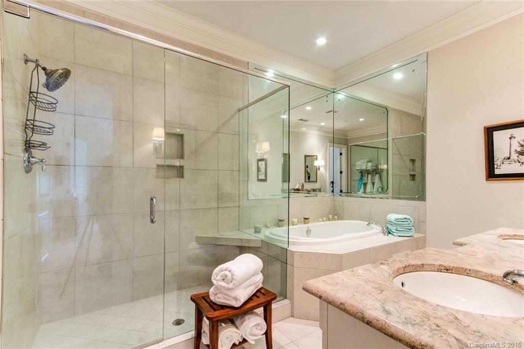 2823 Providence Road, Unit 255 Charlotte, NC 28211 - Photo 15 of 24 a bathroom with a granite countertop sink a toilet a mirror and shower