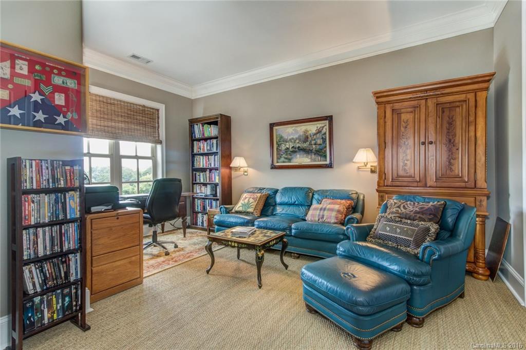 2823 Providence Road, Unit 255 Charlotte, NC 28211 - Photo 16 of 24 a living room with furniture a bookshelf and a window