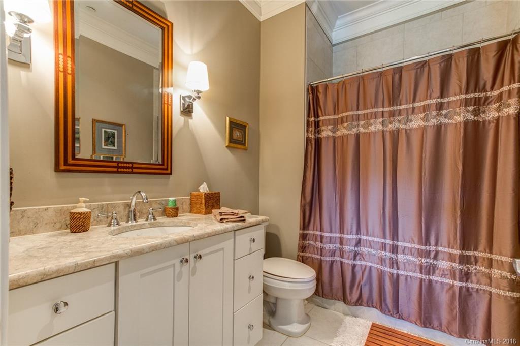 2823 Providence Road, Unit 255 Charlotte, NC 28211 - Photo 17 of 24 a bathroom with a sink a toilet and shower