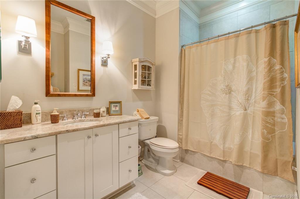 2823 Providence Road, Unit 255 Charlotte, NC 28211 - Photo 20 of 24 a bathroom with a toilet a sink and a mirror