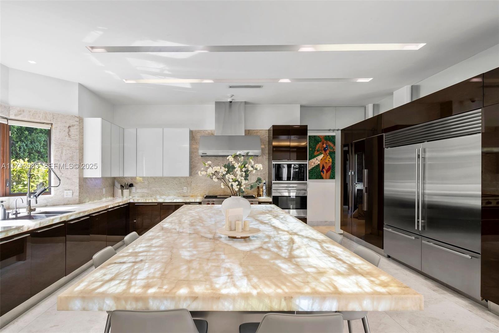 8955 Southwest 63rd Court Pinecrest, FL 33156 - Photo 11 of 59 a kitchen with granite countertop a refrigerator and a sink