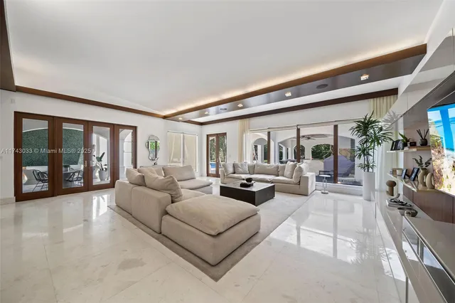 a living room with furniture and view of kitchen