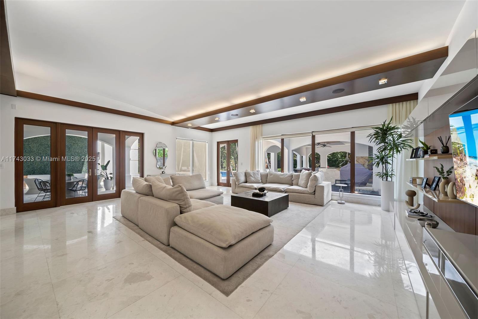 8955 Southwest 63rd Court Pinecrest, FL 33156 - Photo 12 of 59 a living room with furniture and a large window