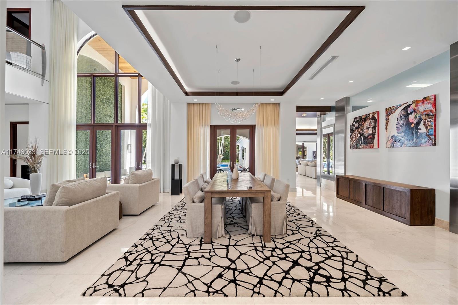 8955 Southwest 63rd Court Pinecrest, FL 33156 - Photo 20 of 59 a living room with furniture and a large window