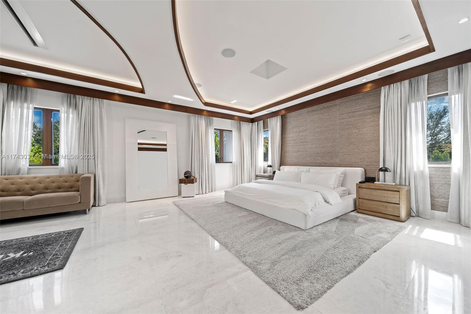 8955 Southwest 63rd Court Pinecrest, FL 33156 - Photo 22 of 59 a spacious bedroom with a large bed and furniture