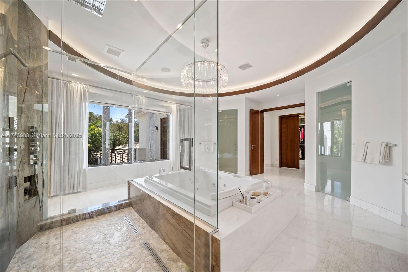 8955 Southwest 63rd Court Pinecrest, FL 33156 - Photo 24 of 59 a spacious en suite bathroom with a tub shower and windows