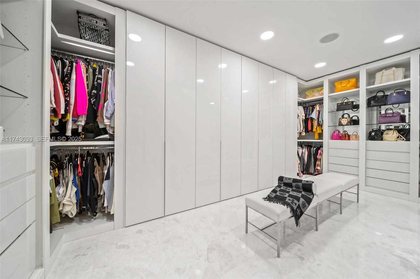 8955 Southwest 63rd Court Pinecrest, FL 33156 - Photo 25 of 59 a view of walk in closet with clothes and shoes