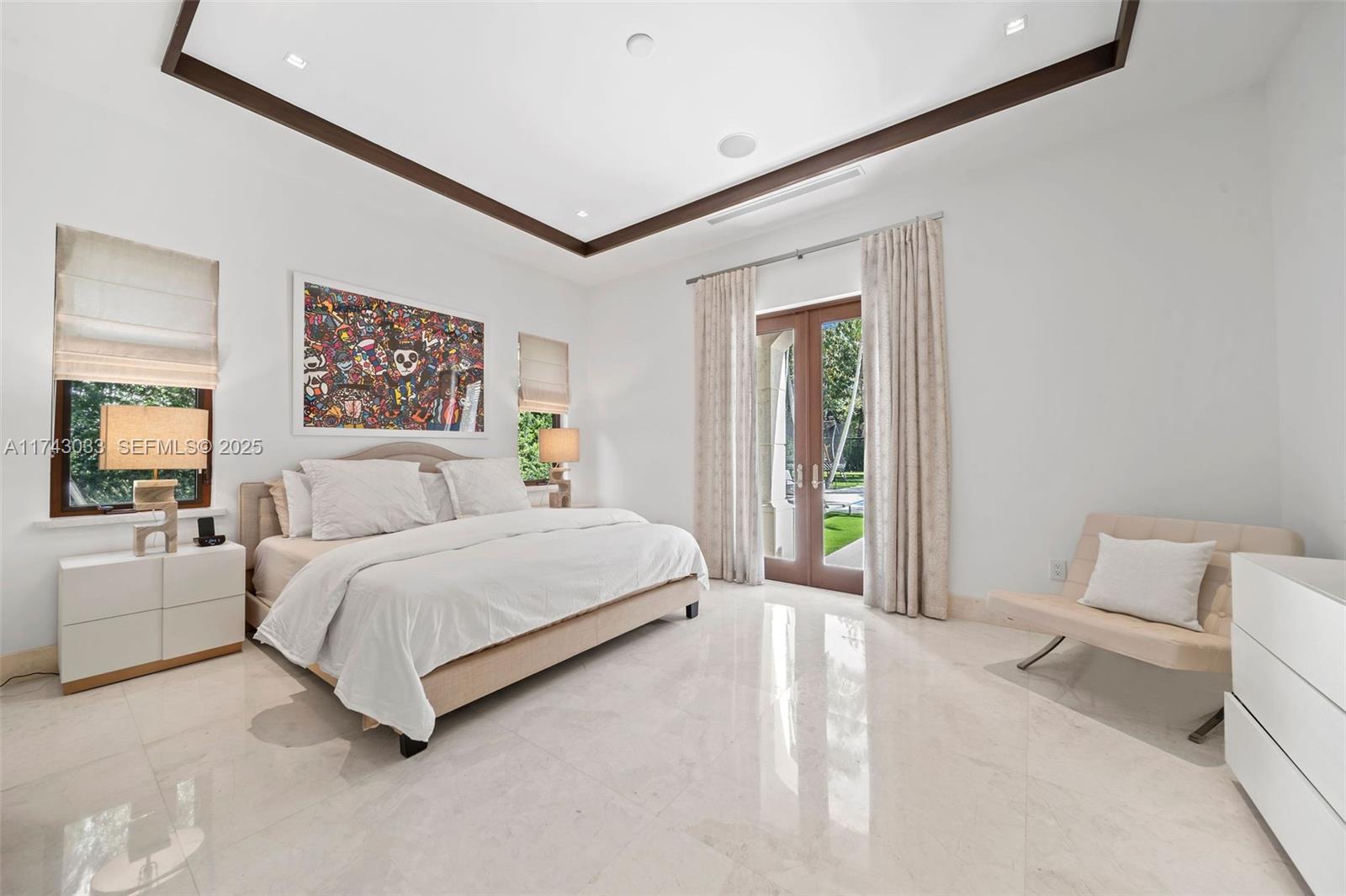 8955 Southwest 63rd Court Pinecrest, FL 33156 - Photo 37 of 59 a spacious bedroom with a bed and a couch