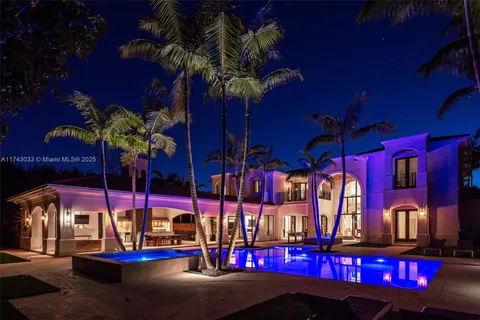 a large white kitchen with a large window