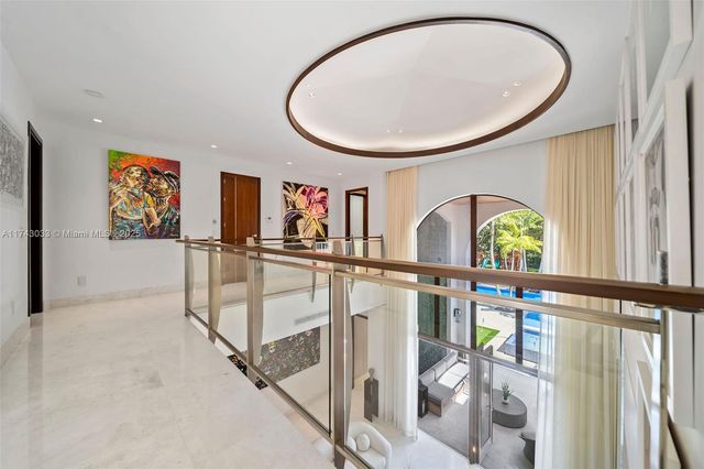 a view of a house with swimming pool and sitting area